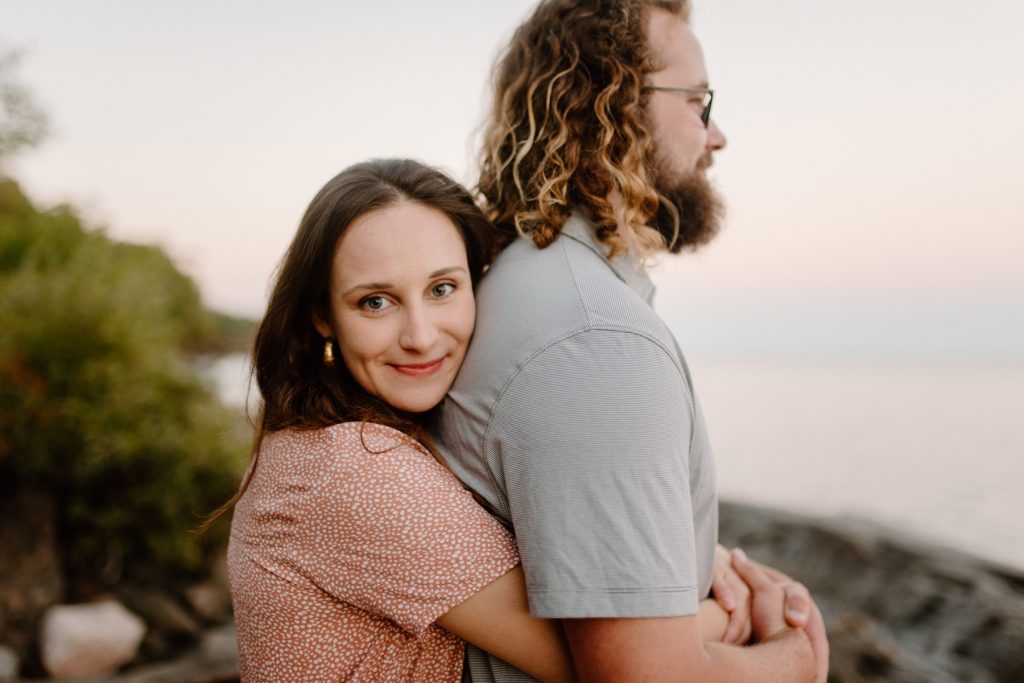 Couple hugging by Lake Superior.