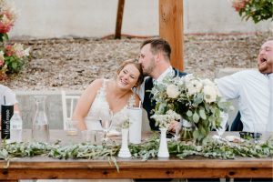Groom kissing bride during reception