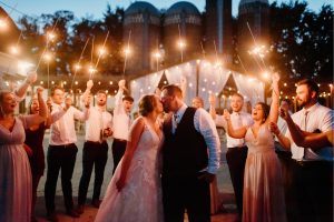 Bride and groom kissing at sparkler exit